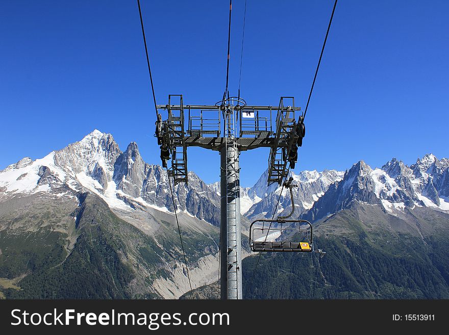 Chair lift and mountains and sky blue