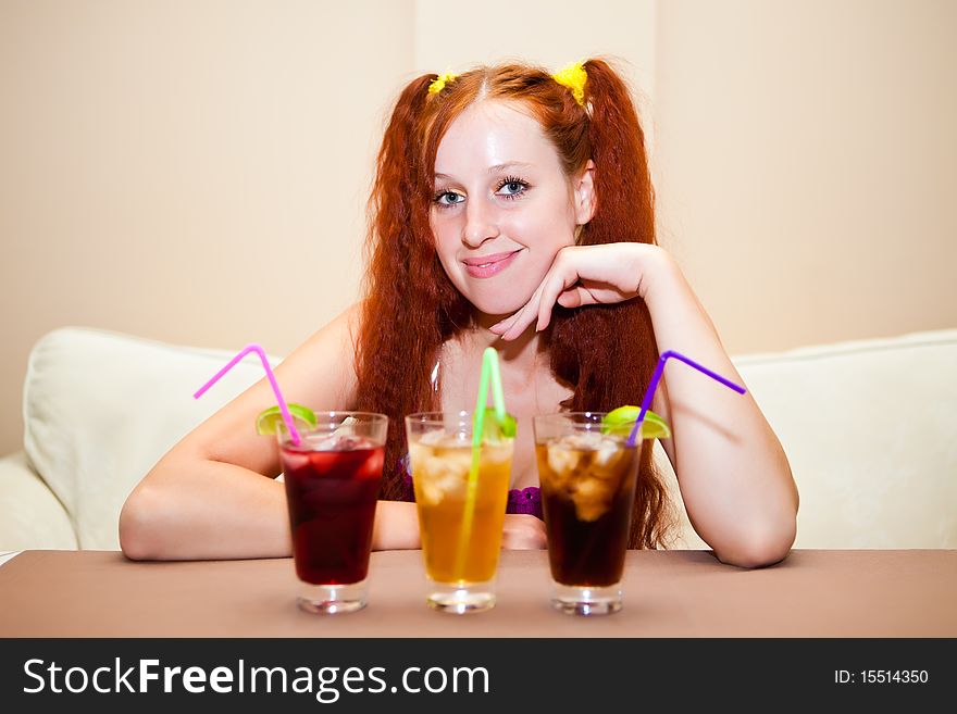 Girl with cocktails in cafe