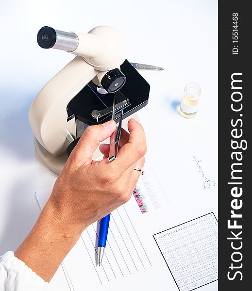 Microscope and doctor on white background