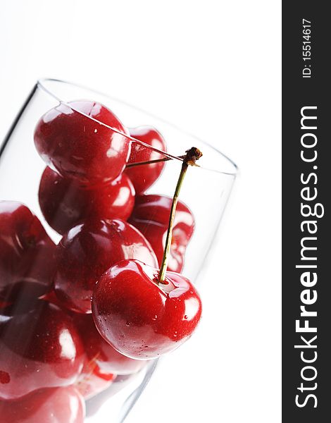 Cherries in a glass on white background