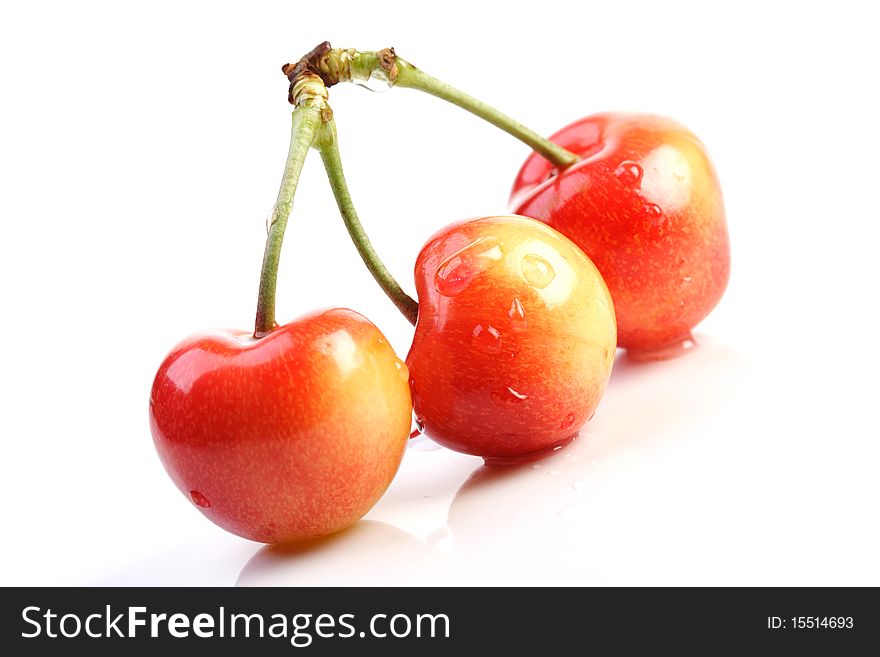 Three cherries on white background