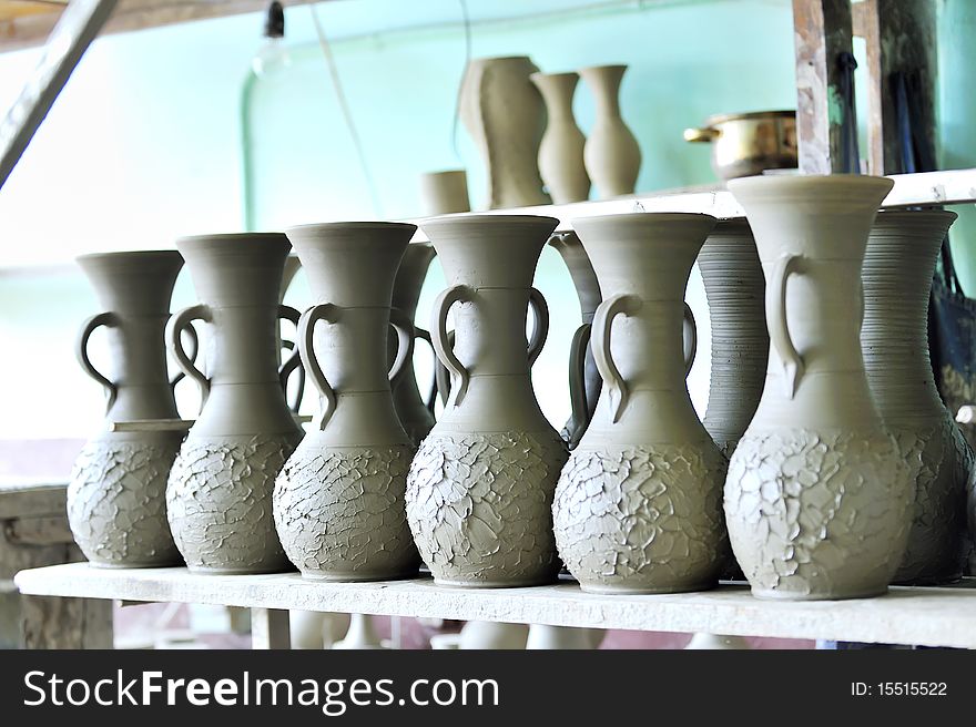 Drying ceramic vase inside of workshop on shelf