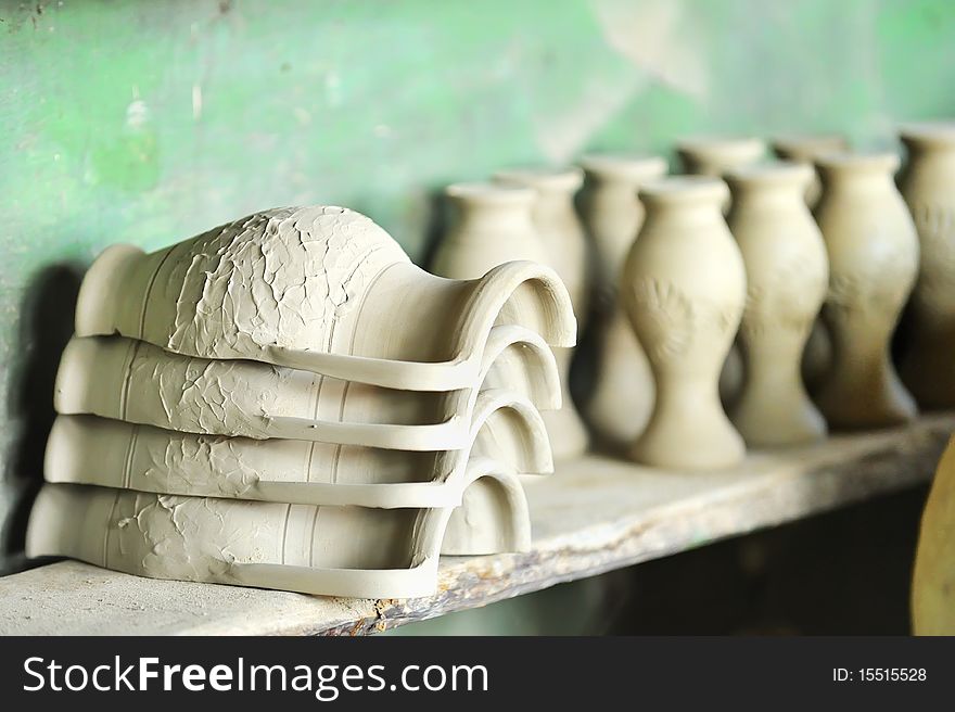 Drying ceramic vase inside of workshop on shelf