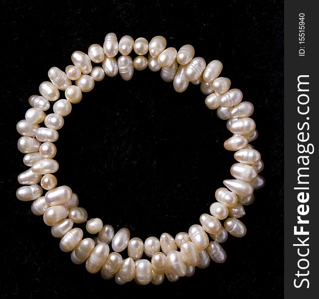 Pearl bracelet over black velvet