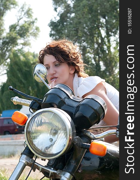 Photo of a beautiful girl, on a old motorcycle. Photo of a beautiful girl, on a old motorcycle.