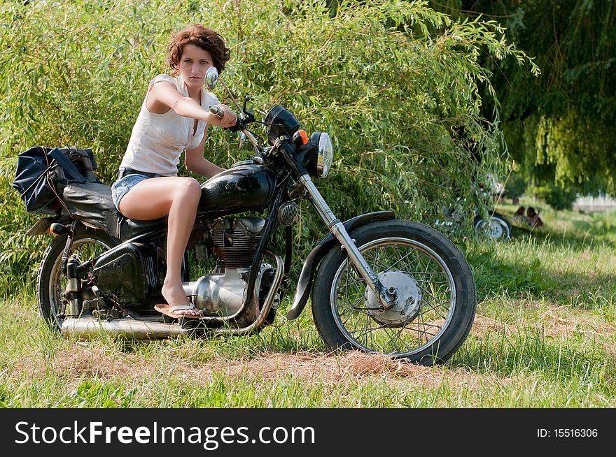 Photo of a beautiful girl, on a old motorcycle. Photo of a beautiful girl, on a old motorcycle.