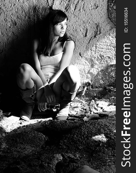 black and white photo with caucasian teenager thinking in demolished building. black and white photo with caucasian teenager thinking in demolished building