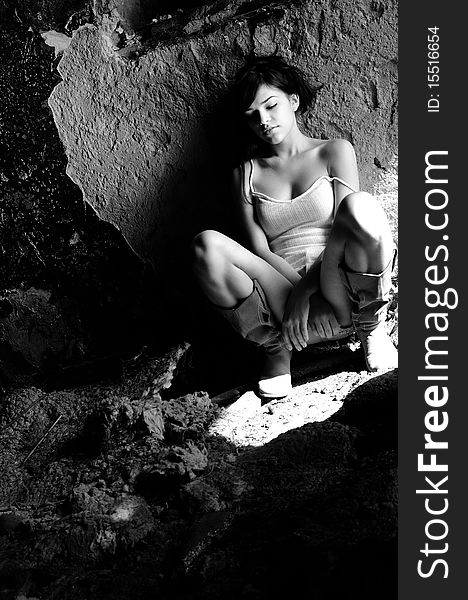 black and white photo with caucasian teenager concentrating in demolished building. black and white photo with caucasian teenager concentrating in demolished building