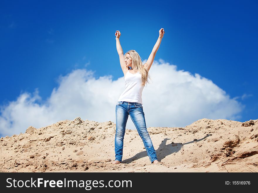 Young beautiful girl against the dark blue sky