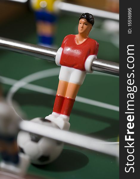 Playing tabletop soccer with red and yellow figures