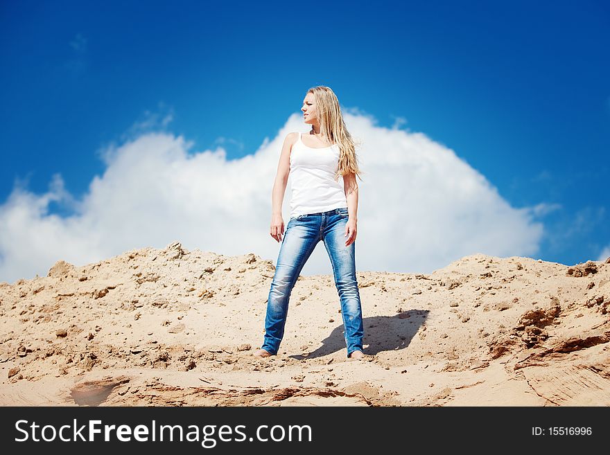 Young beautiful girl against the dark blue sky