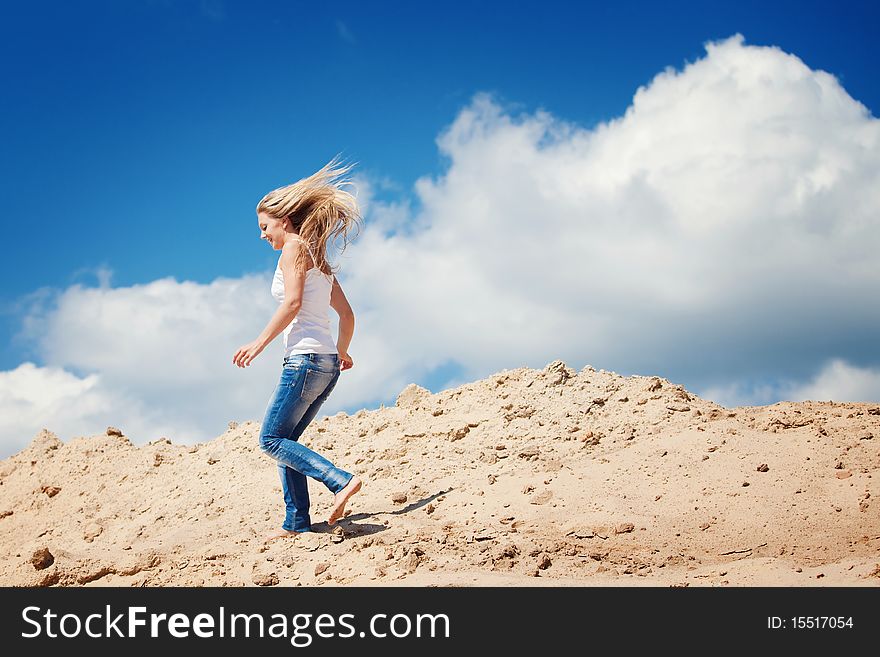 Young beautiful girl against the dark blue sky