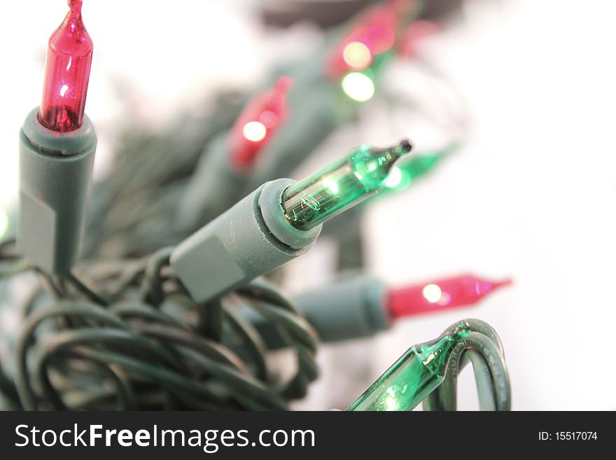 Red and green christmas light over white background. Red and green christmas light over white background