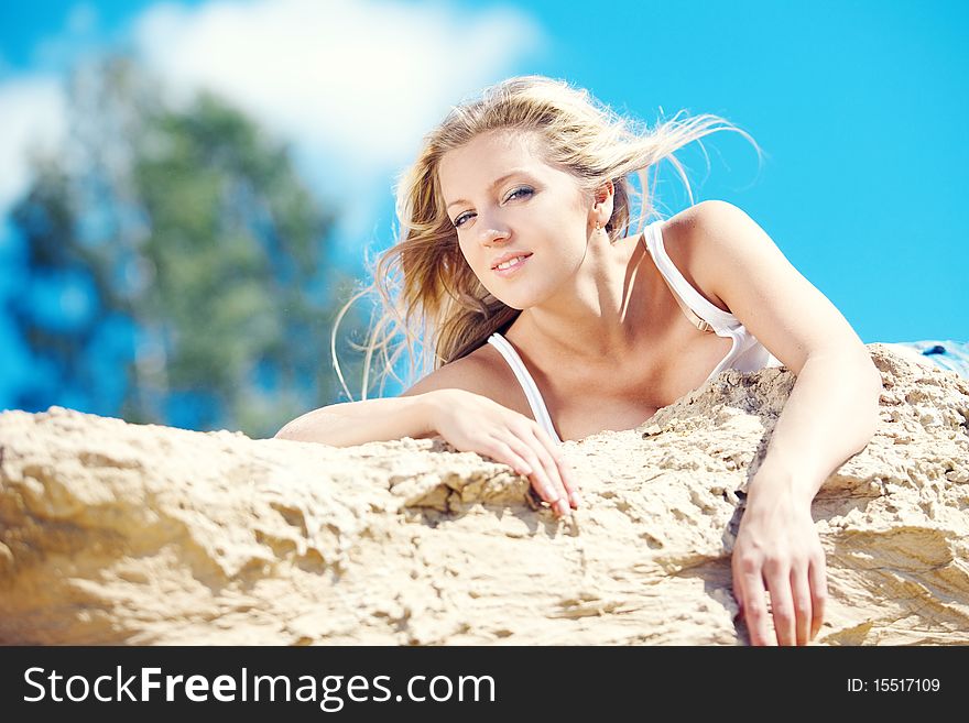 Young beautiful blonde with developing on a wind hair