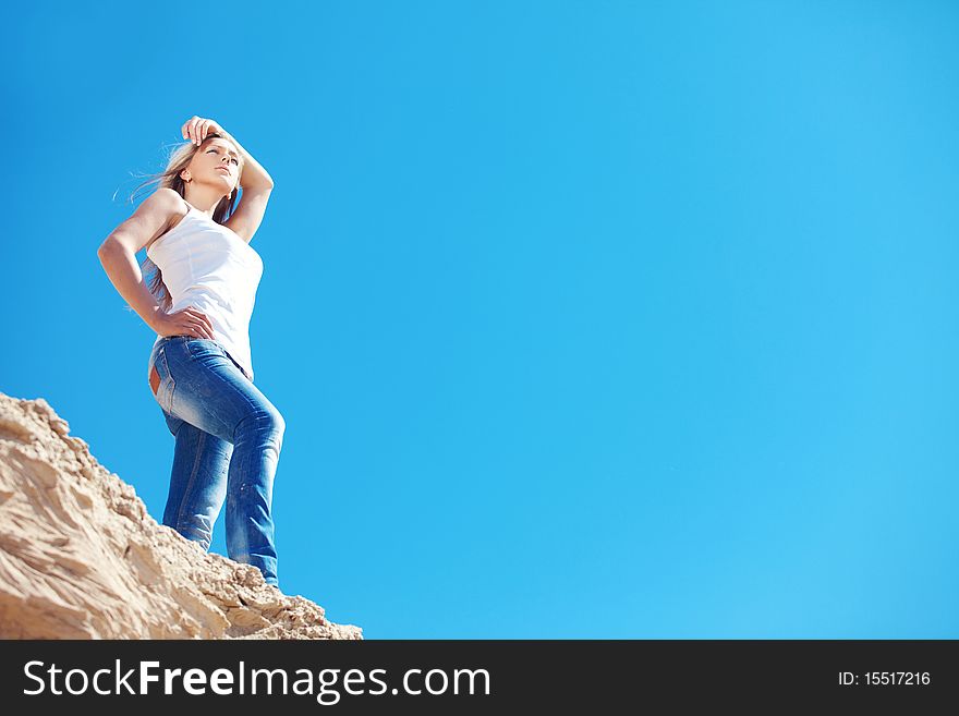 Young beautiful girl against the dark blue sky