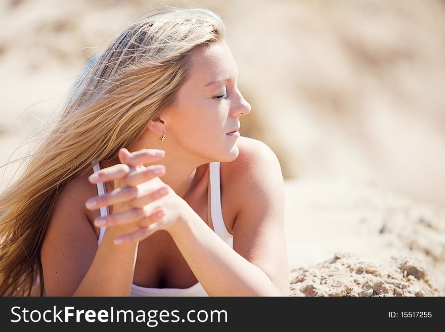 Young beautiful blonde with developing on a wind hair