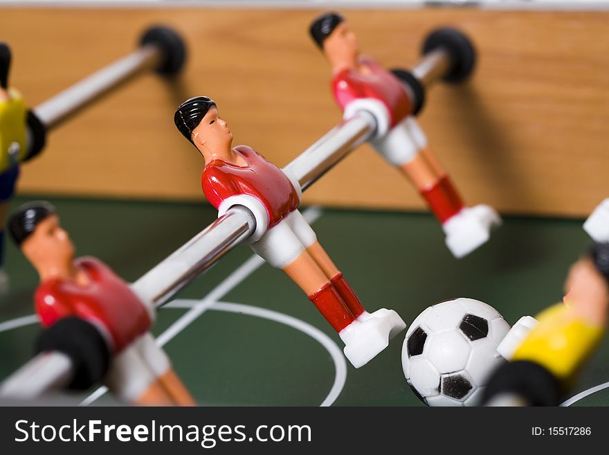 Playing tabletop soccer with red and yellow figures