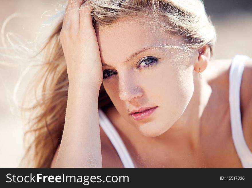 Young beautiful blonde with developing on a wind hair