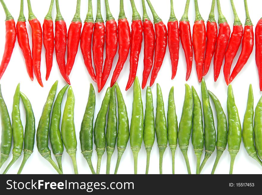 Red and green chili on white background