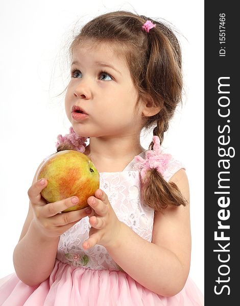 Child with pigtails eating ripe apple