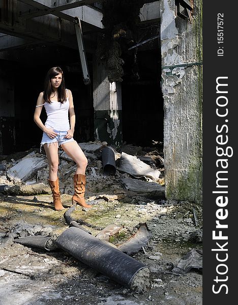 Brunette young woman posing in devastated building. Brunette young woman posing in devastated building