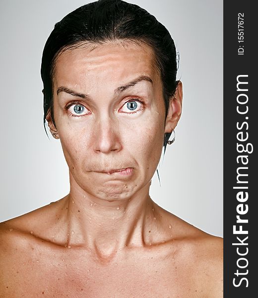 Facial portrait of offended woman with drops on a skin. Facial portrait of offended woman with drops on a skin