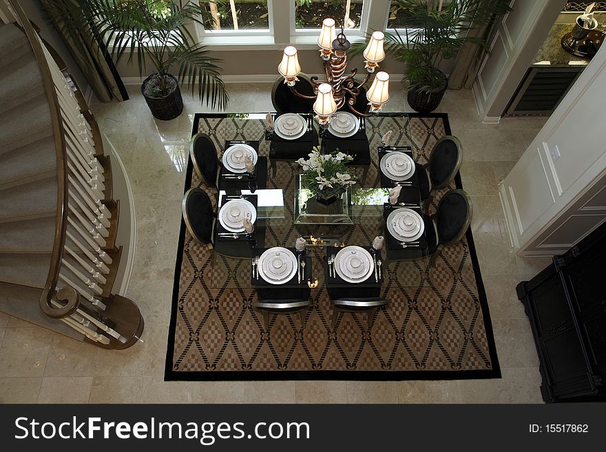 Dining room table with luxurious tableware and decor.