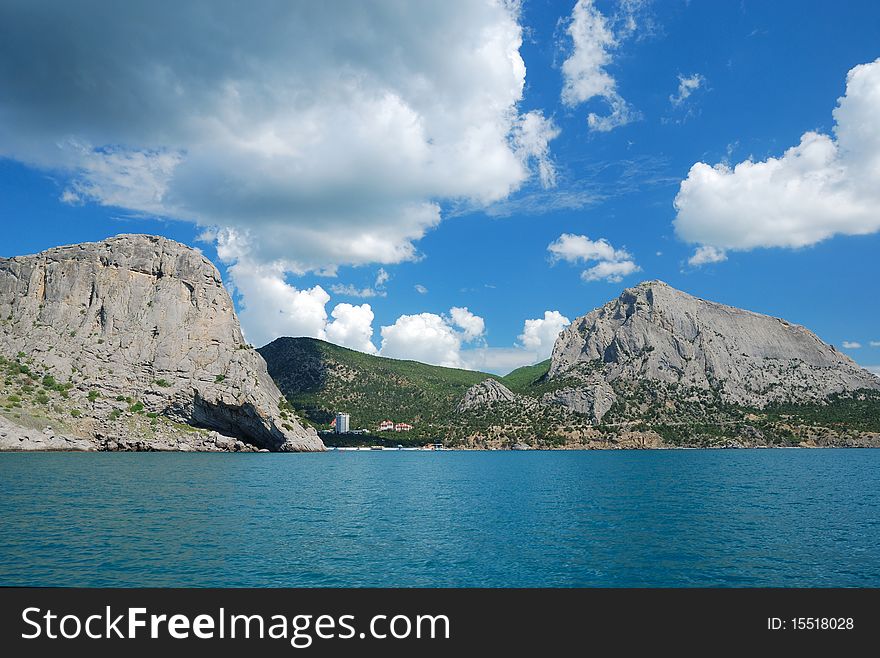 Green bay of Noviy Svet is located between two mountains. It is photographed from the sea. Green bay of Noviy Svet is located between two mountains. It is photographed from the sea.