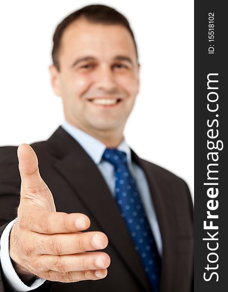 Smiling businessman offering handshake, selective focus on hand. Smiling businessman offering handshake, selective focus on hand