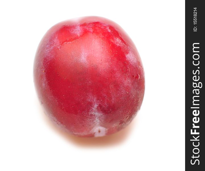 One plum on a white background, isolation. One plum on a white background, isolation