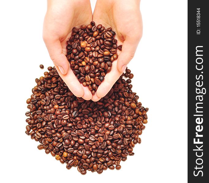 Female hands full of coffee beans over white background