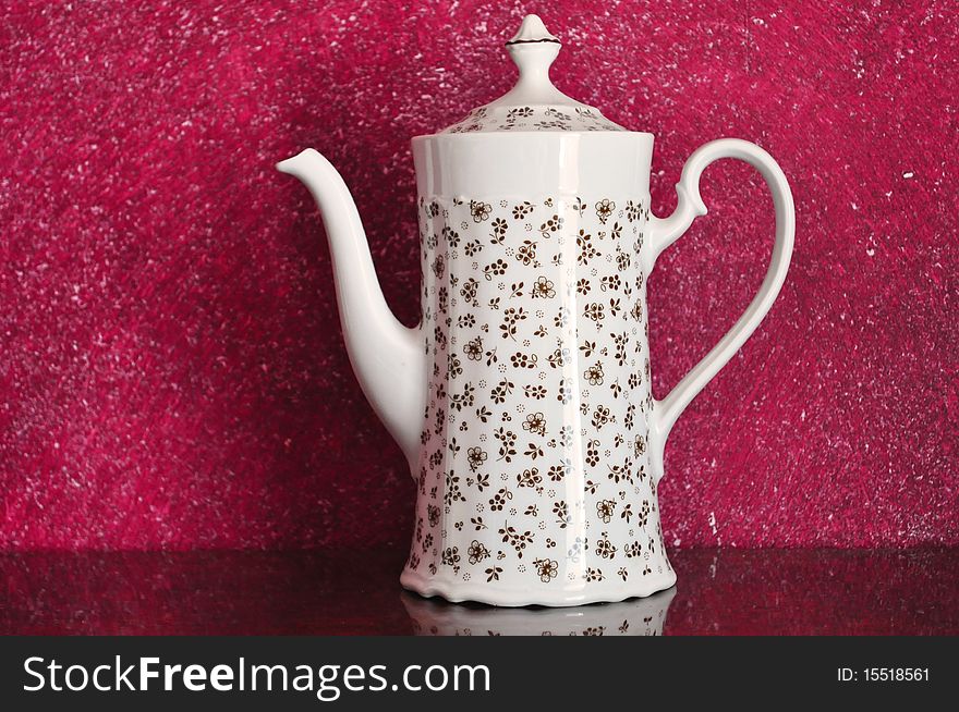 Image of a beautiful teapot on magenta background