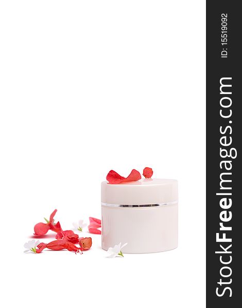 Cosmetic container and flower petals on a white background. Cosmetic container and flower petals on a white background.