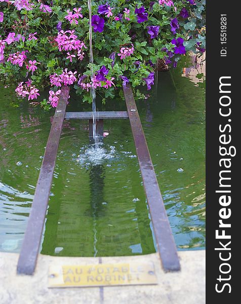 Public drinking water flourish fountain in France. Public drinking water flourish fountain in France..