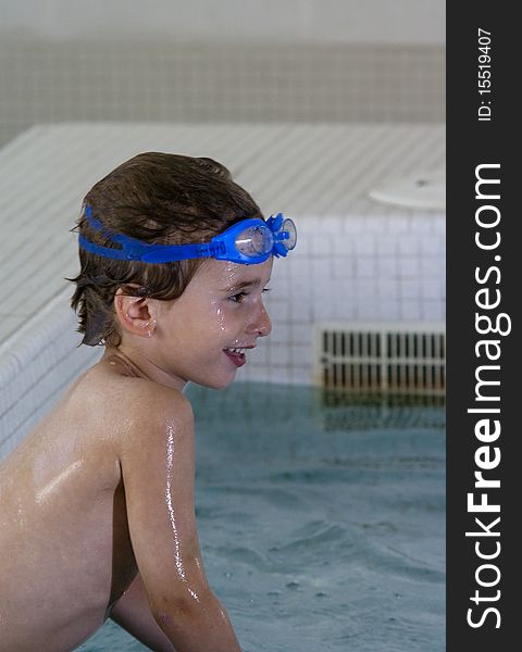 Boy with goggles in a pool