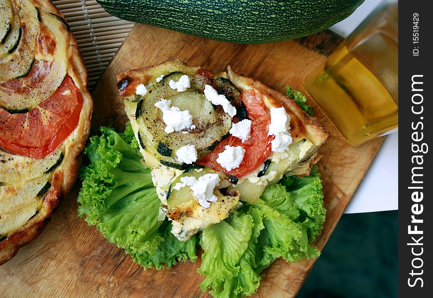 Shows summer pie with zucchini and tomatoes. Shows summer pie with zucchini and tomatoes