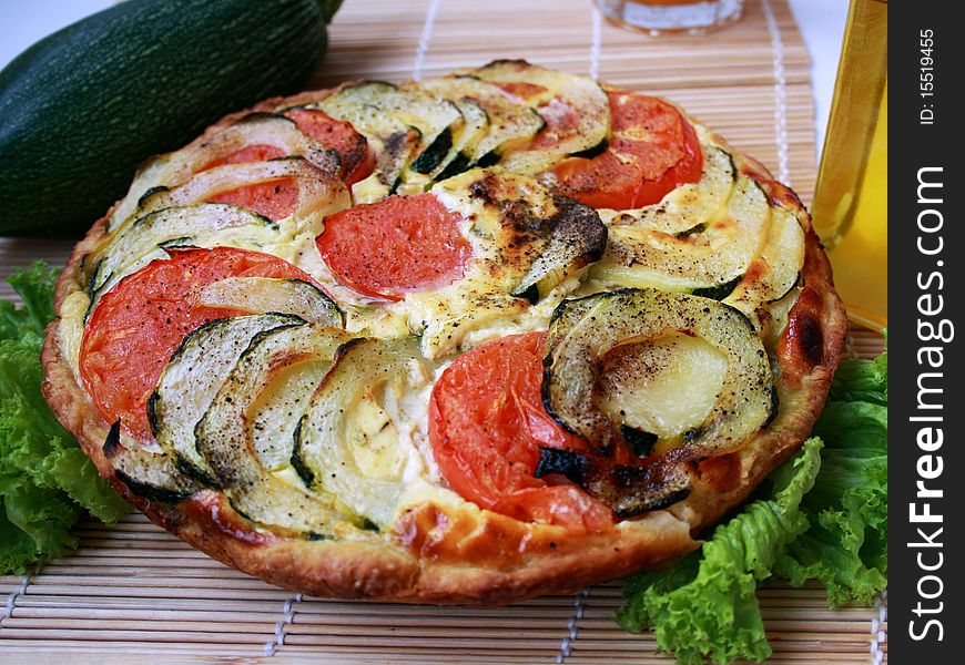 Shows summer pie with zucchini and tomatoes. Shows summer pie with zucchini and tomatoes