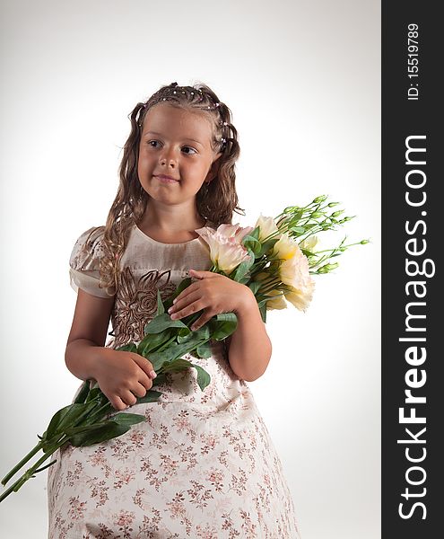 Cute little girl with pigtail hairstyle holding flowers, studio shot. Cute little girl with pigtail hairstyle holding flowers, studio shot