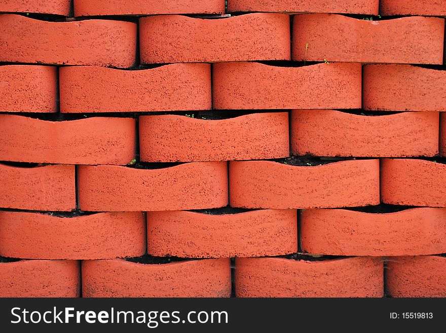 Red Terracotta Brick Wall Background with Soil and Plant