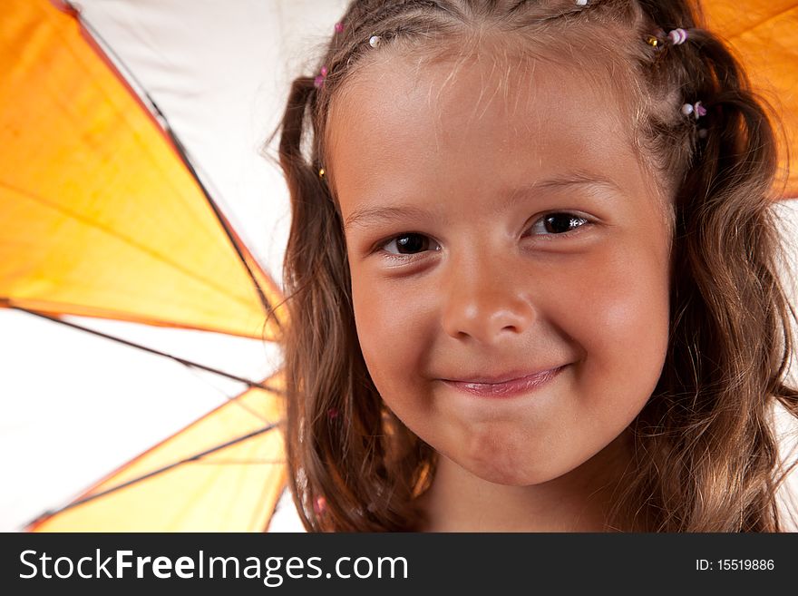 Close-up shot of cute little girl with orange umbrella