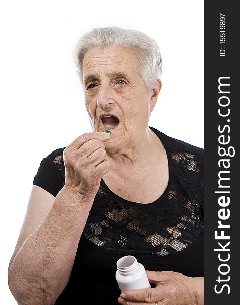 A senior woman with pills in her hand. A senior woman with pills in her hand