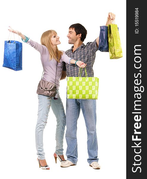 Beautiful young couple with shopping bags, isolated on white background