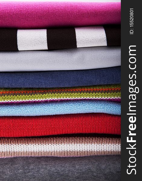 Background with folded multicolored clothes. Background with folded multicolored clothes