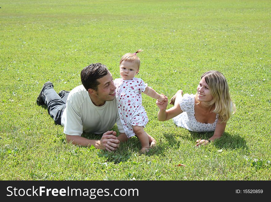 Happy family on the green grass