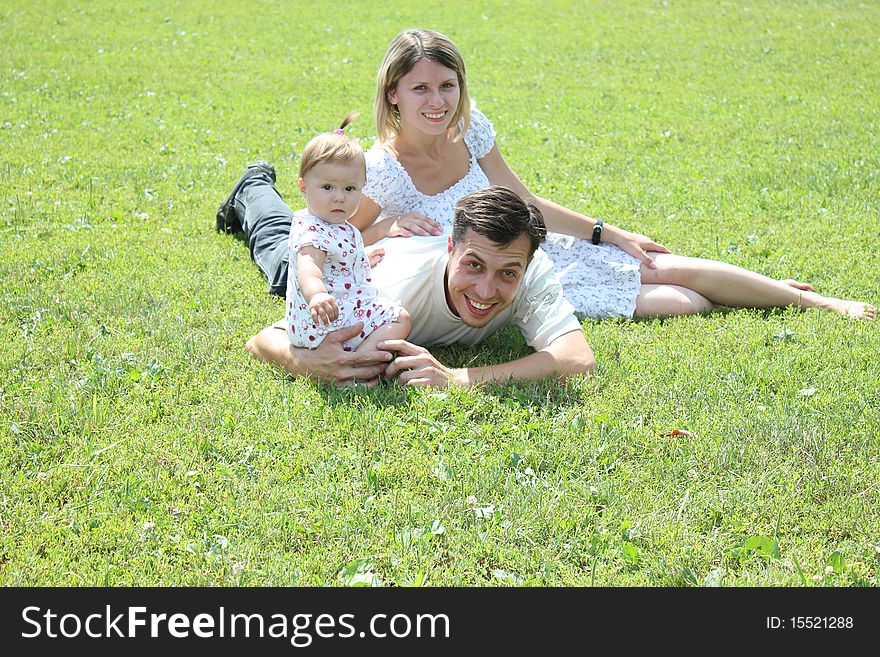 Young family on the green grass