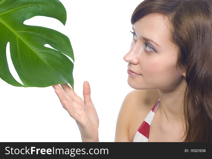 Young woman on a white background with a green leaf. Young woman on a white background with a green leaf