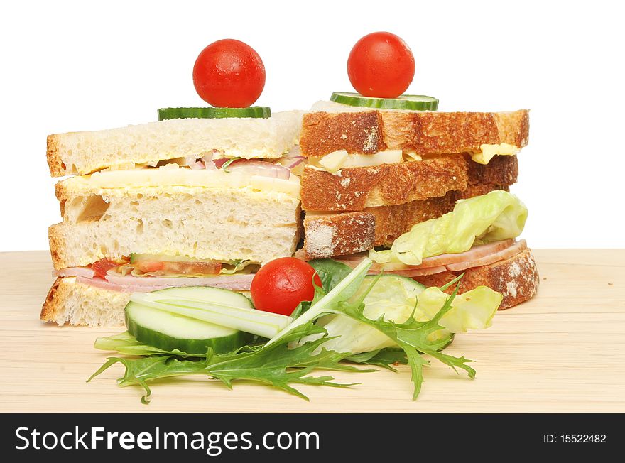 Club sandwich with salad on a wooden board. Club sandwich with salad on a wooden board