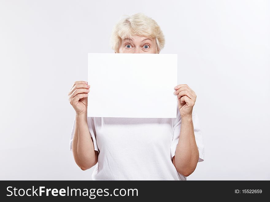 Mature woman with surprised eyes with a blank form. Mature woman with surprised eyes with a blank form