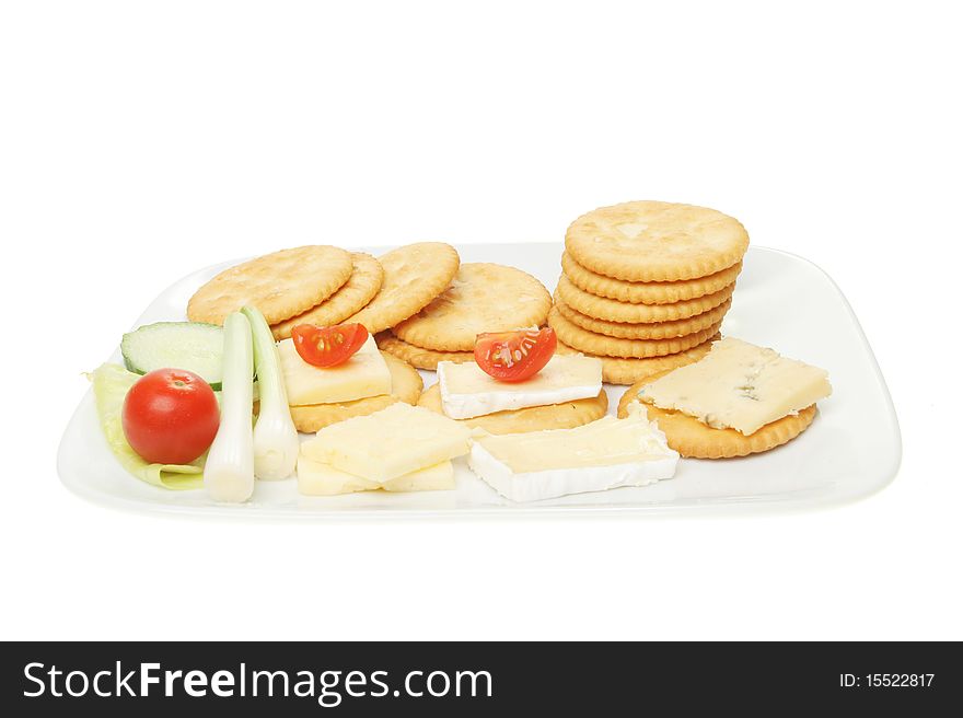 Biscuits cheese and salad on a plate isolated on white