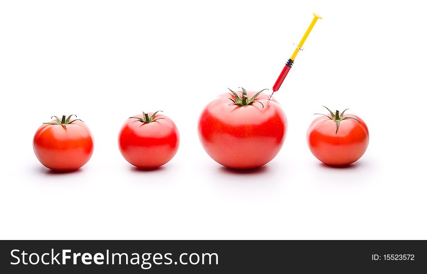 Injecting red liquid in big tomato. Useful for genetic modification concepts. Injecting red liquid in big tomato. Useful for genetic modification concepts.